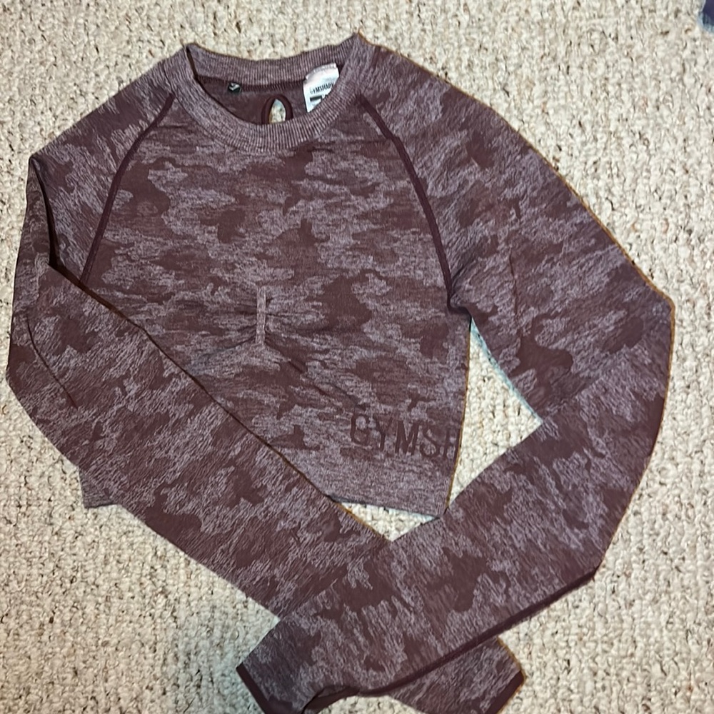 Gymshark long sleeve cropped shirt with cut outs in back. Size Medium.